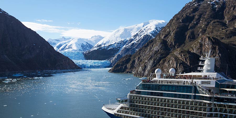 The Celebrity cruise ship travels through the icy water. 